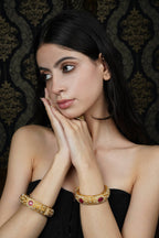 Intricate Gold-Toned Bangle with Ruby & Pearl Accents